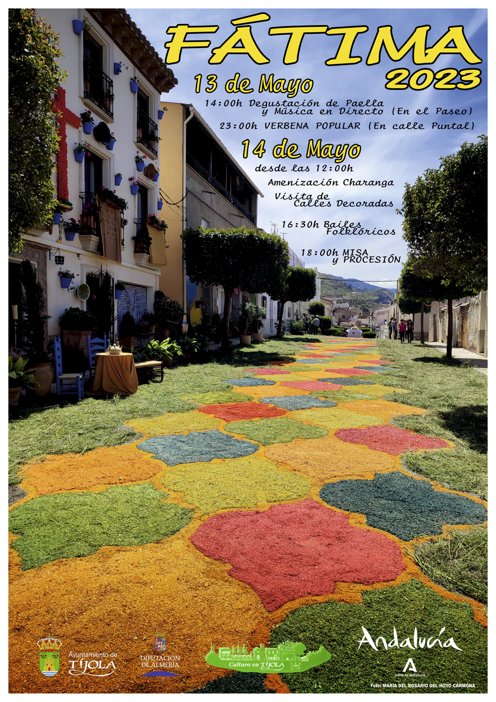 Imagen del Cartel de la Celebración de la Virgen de Fátima 2023. Imagen de alfombra en la calle ancha en honor a la Virgen de Fátima al fondo e información de los eventos..